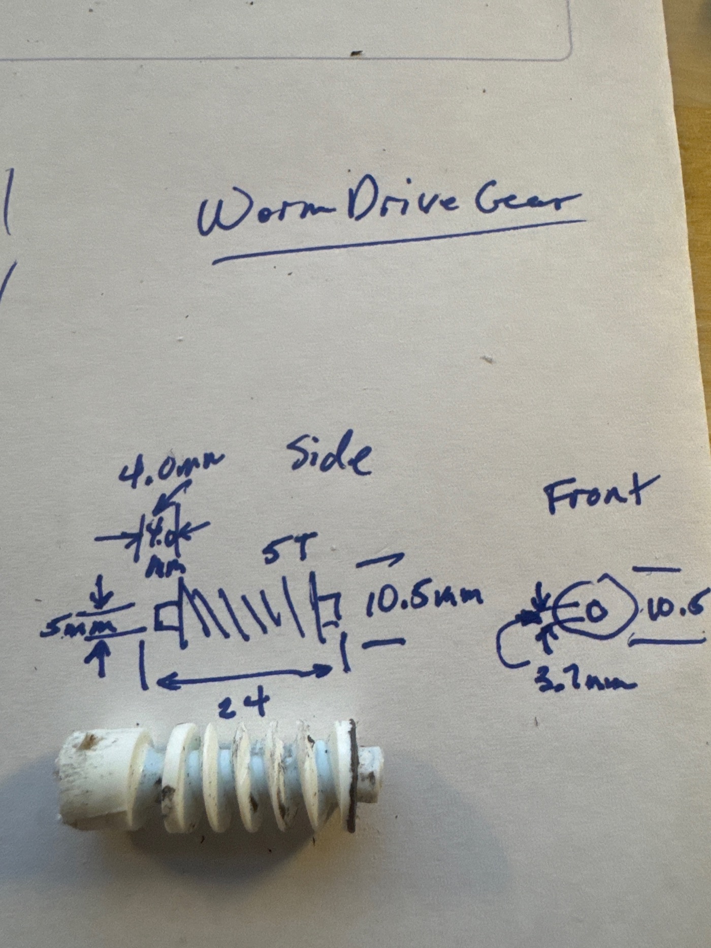 Hand-drawn dimension sketch with the actual parts lying on it